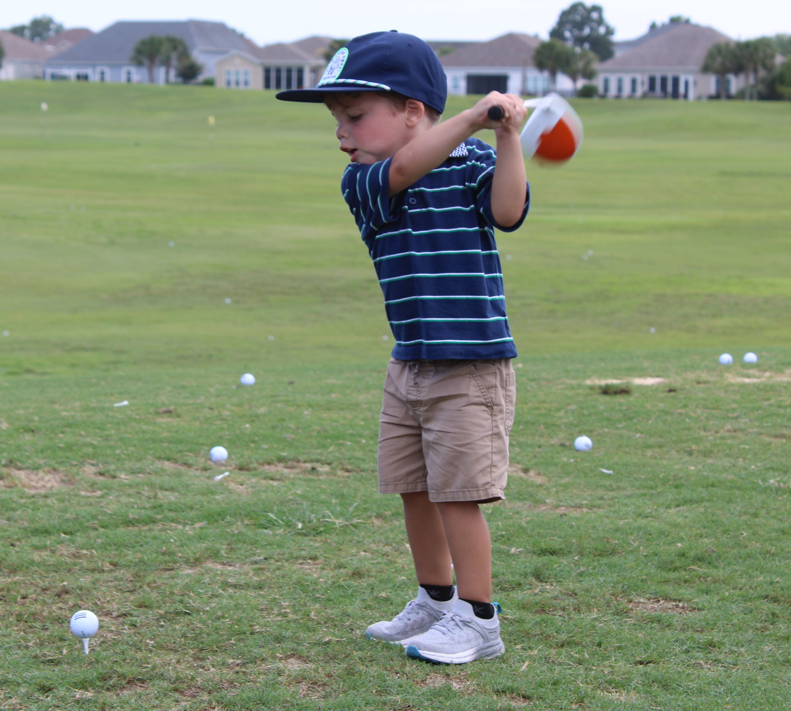 Young golfer participating in Family Golf Week activities