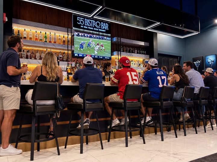 Guests watching football at 55 Bistro Bar