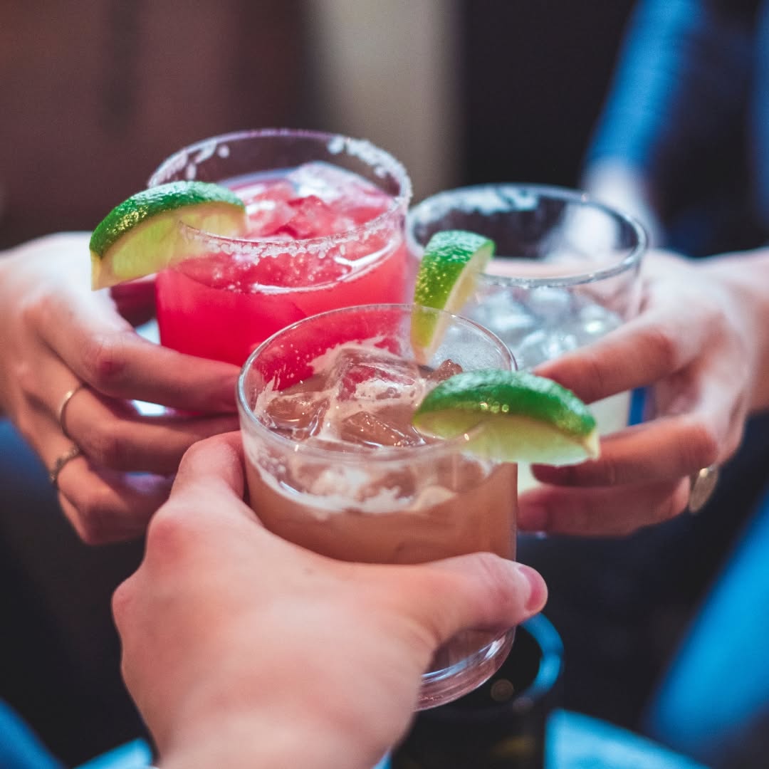 Guests raising cocktails together